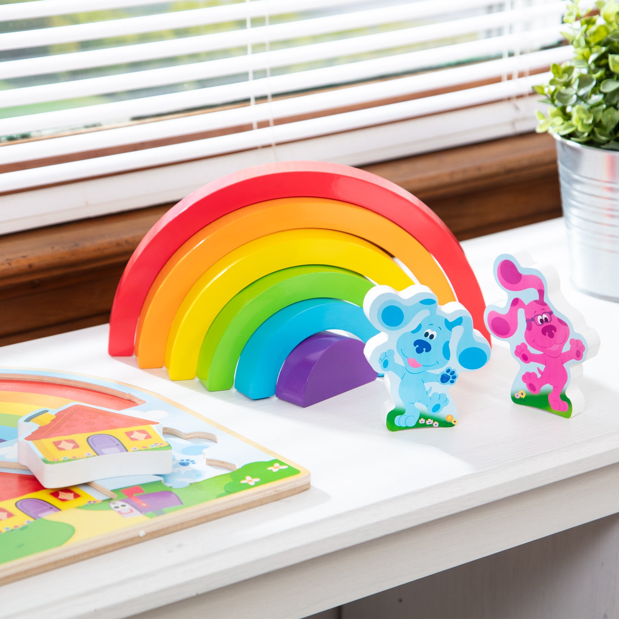 Melissa & Doug wooden rainbow stacking puzzle with blue and pink animal pieces
