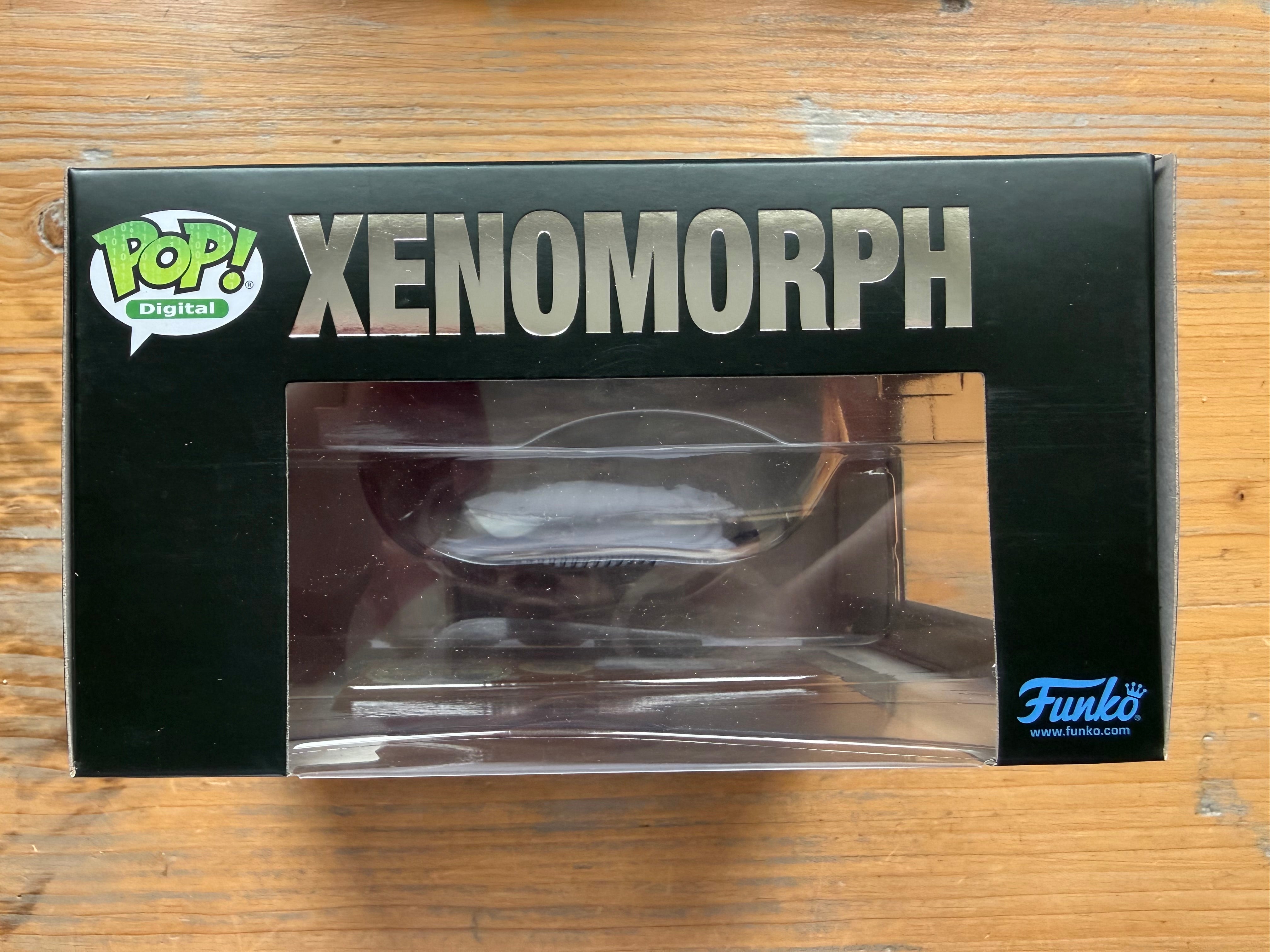 Funko Pop! Digital Xenomorph figure in retail box, window display on black packaging