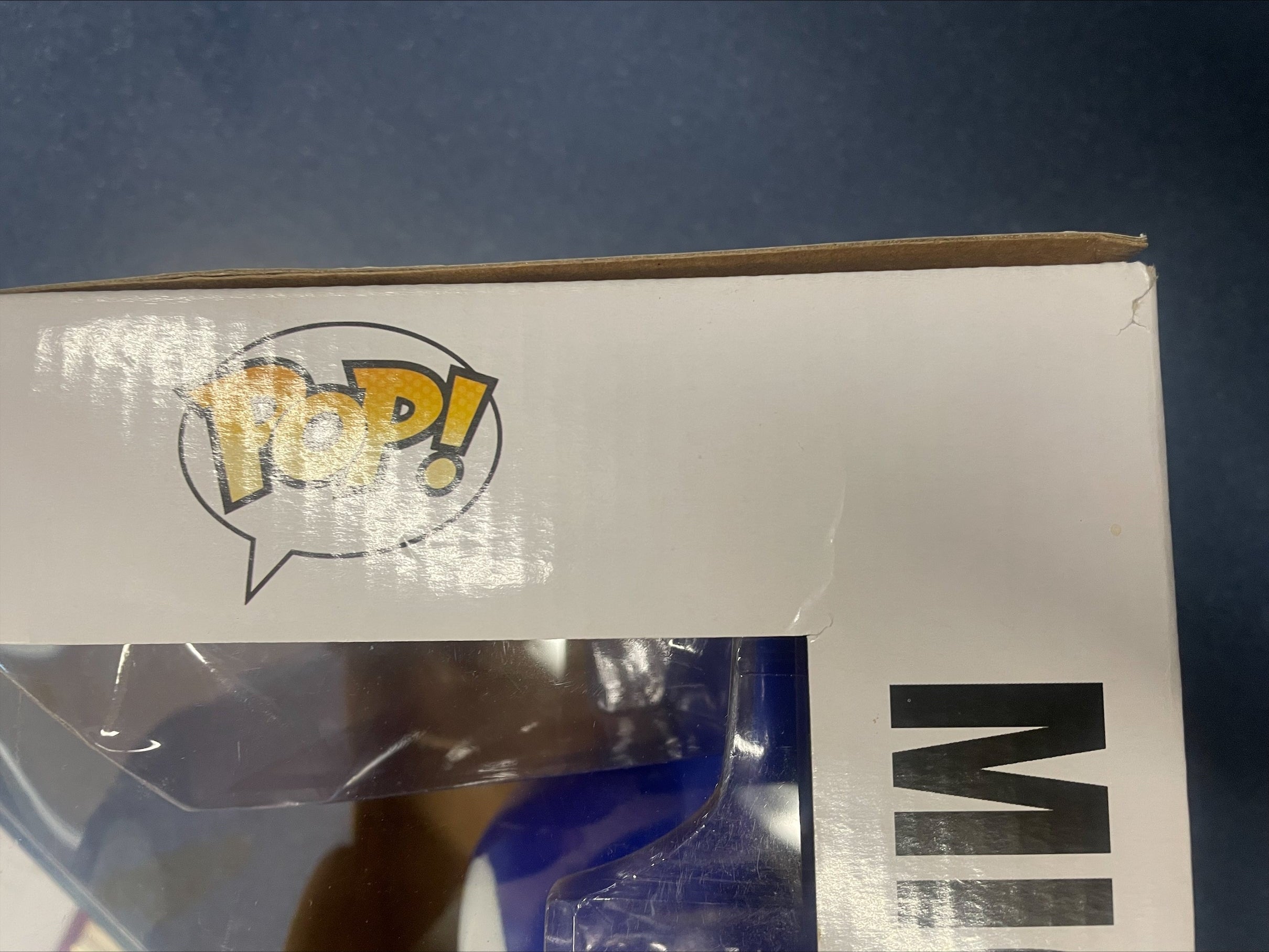 Funko Pop box side panel with POP! logo and clear window, damaged