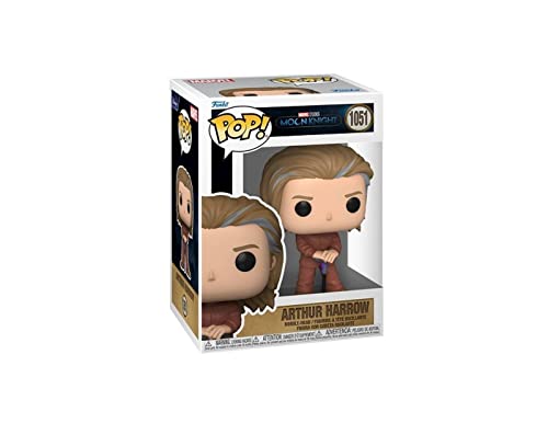Vinyl collectible figure with tan hair and brown outfit, hands clasped in front