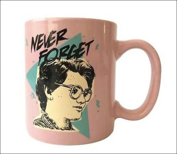 Pink mug with a graphic of a person with glasses and text 'Never Forget' on a white background