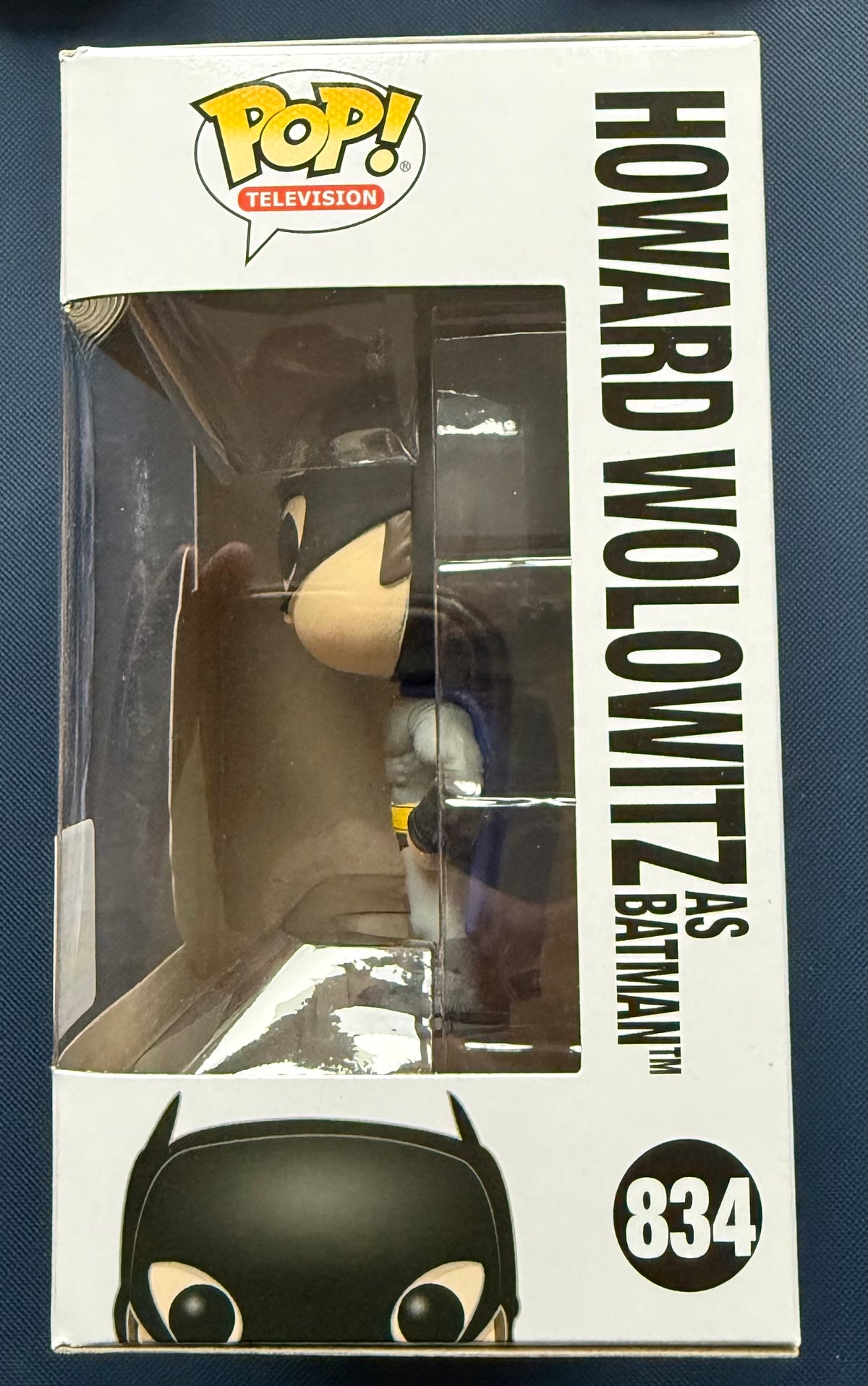 Howard Wolowitz as Batman Funko Pop in box window, number 834 on side panel