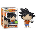 Vinyl Goku collectible figure with spiky black hair, orange top, holding steering wheel